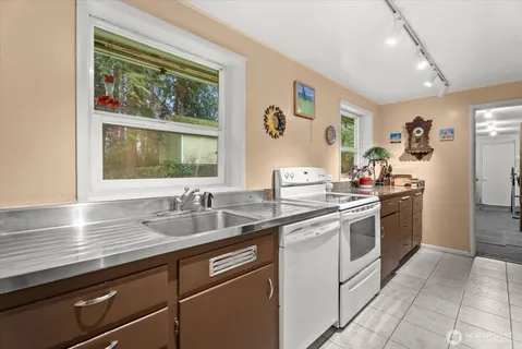 a kitchen with a sink stove and cabinets