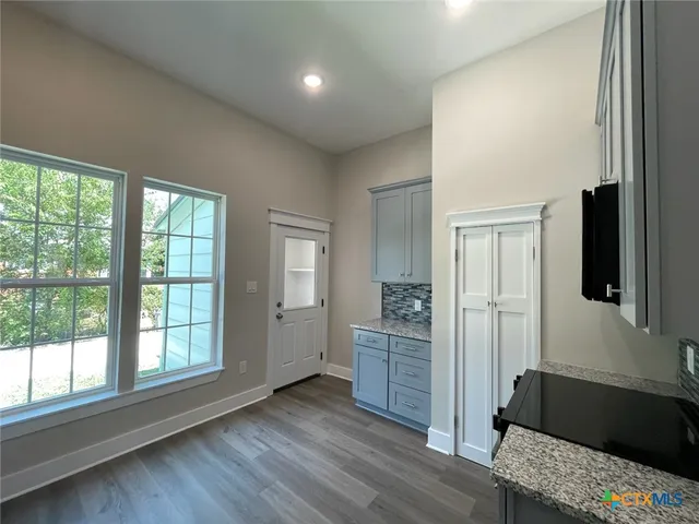 a living room with a bed furniture and a window