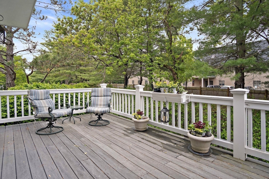 1 Abington Road, Unit 1 Danvers, MA 01923 - Photo 12 of 31 a view of balcony with chairs and wooden fence