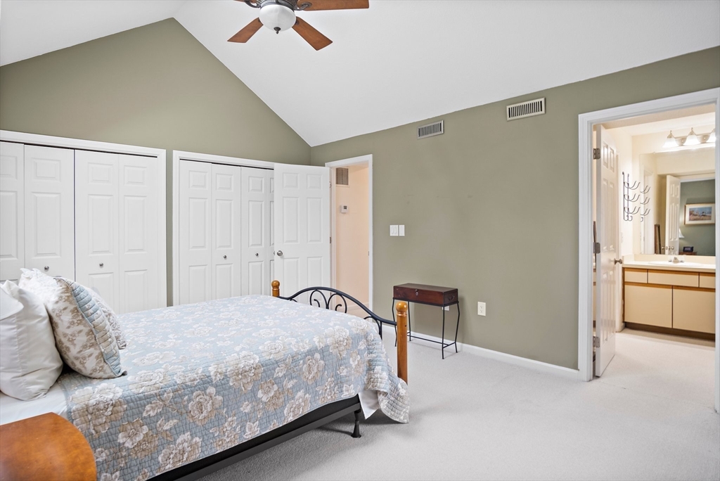 1 Abington Road, Unit 1 Danvers, MA 01923 - Photo 15 of 31 a bedroom with a bed and a chandelier