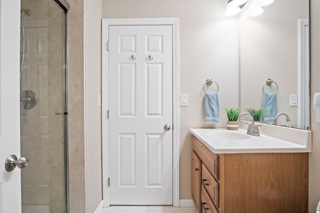1 Abington Road, Unit 1 Danvers, MA 01923 - Photo 17 of 31 a bathroom with a sink vanity and a mirror
