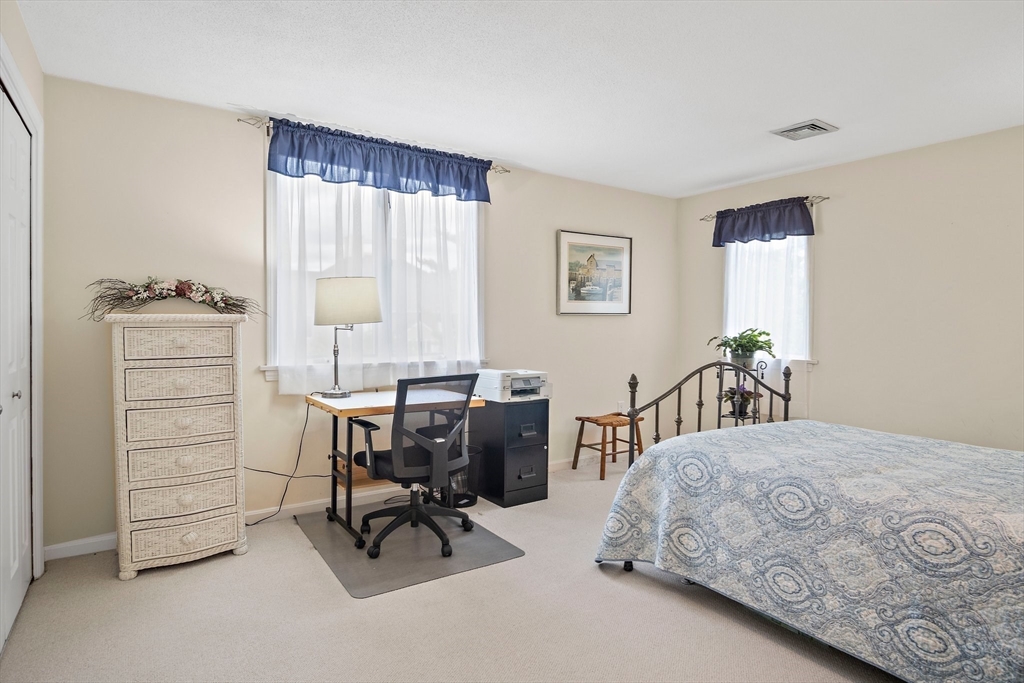 1 Abington Road, Unit 1 Danvers, MA 01923 - Photo 21 of 31 a bedroom with a bed and a desk