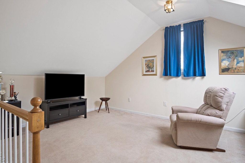 1 Abington Road, Unit 1 Danvers, MA 01923 - Photo 22 of 31 a living room with furniture and a flat screen tv