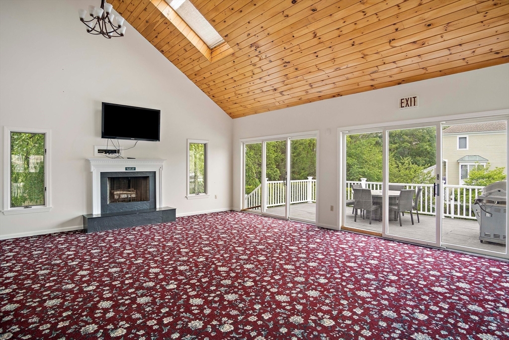 1 Abington Road, Unit 1 Danvers, MA 01923 - Photo 30 of 31 a living room with a flat screen tv and a fireplace