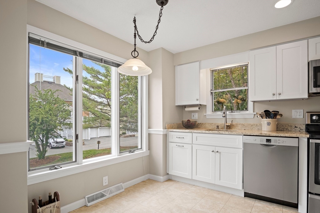 1 Abington Road, Unit 1 Danvers, MA 01923 - Photo 3 of 31 a kitchen with a sink window and cabinets