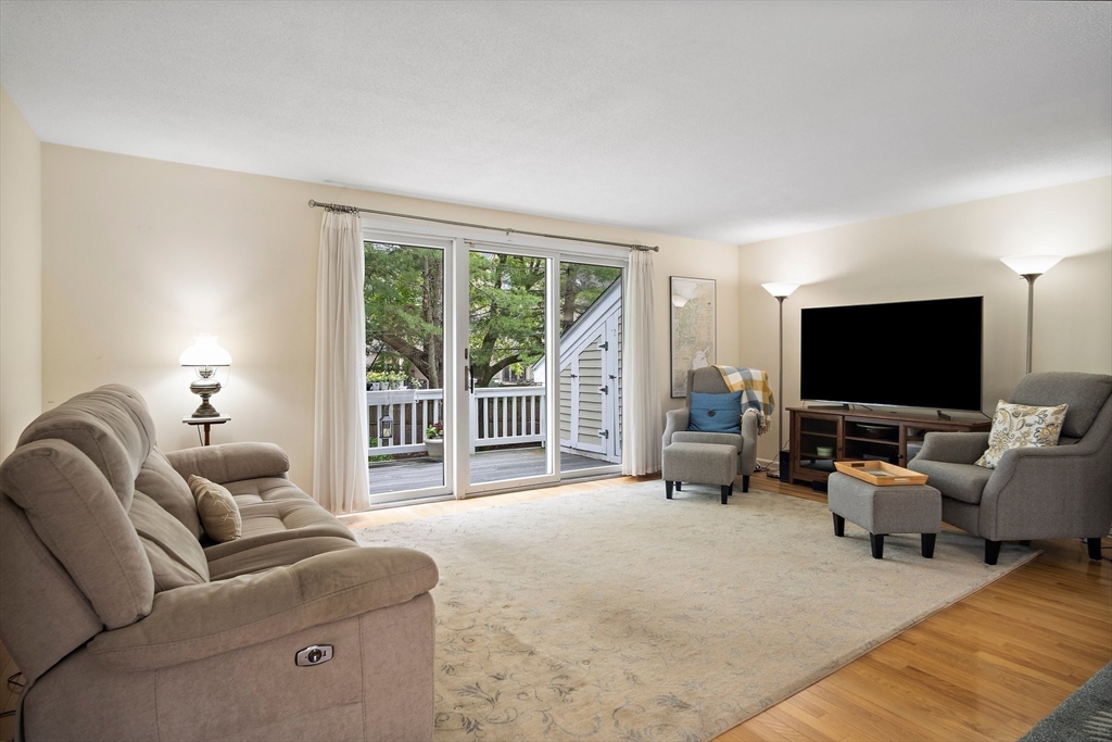 1 Abington Road, Unit 1 Danvers, MA 01923 - Photo 7 of 31 a living room with furniture and a flat screen tv
