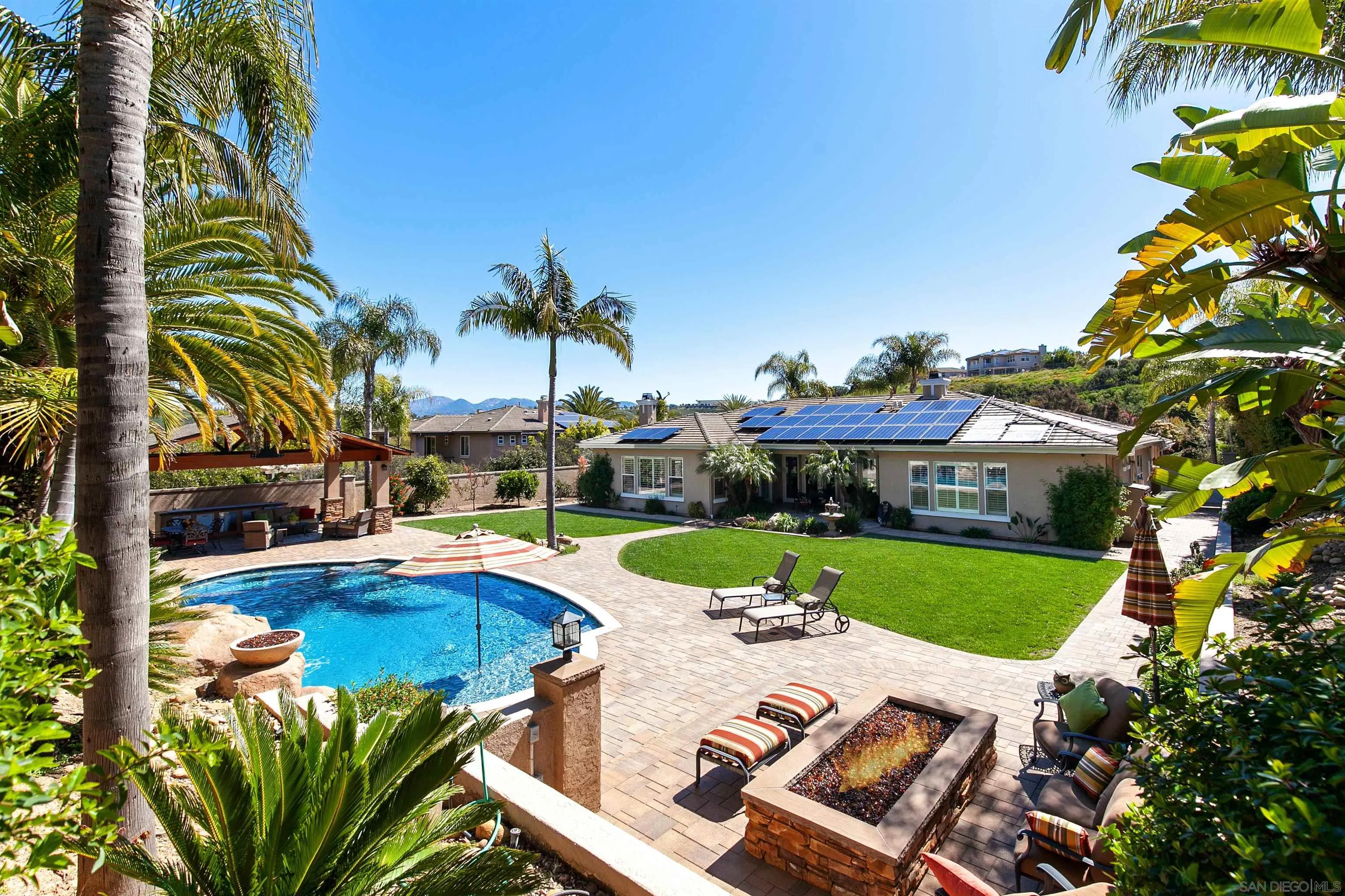 11760 Treadwell Drive Poway, CA 92064 - Photo 45 of 52 a view of a swimming pool with lawn chairs under an umbrella