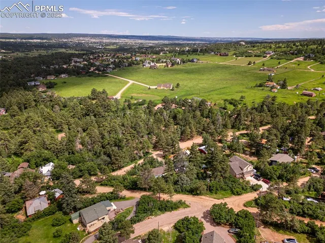 a view of a city with lush green forest
