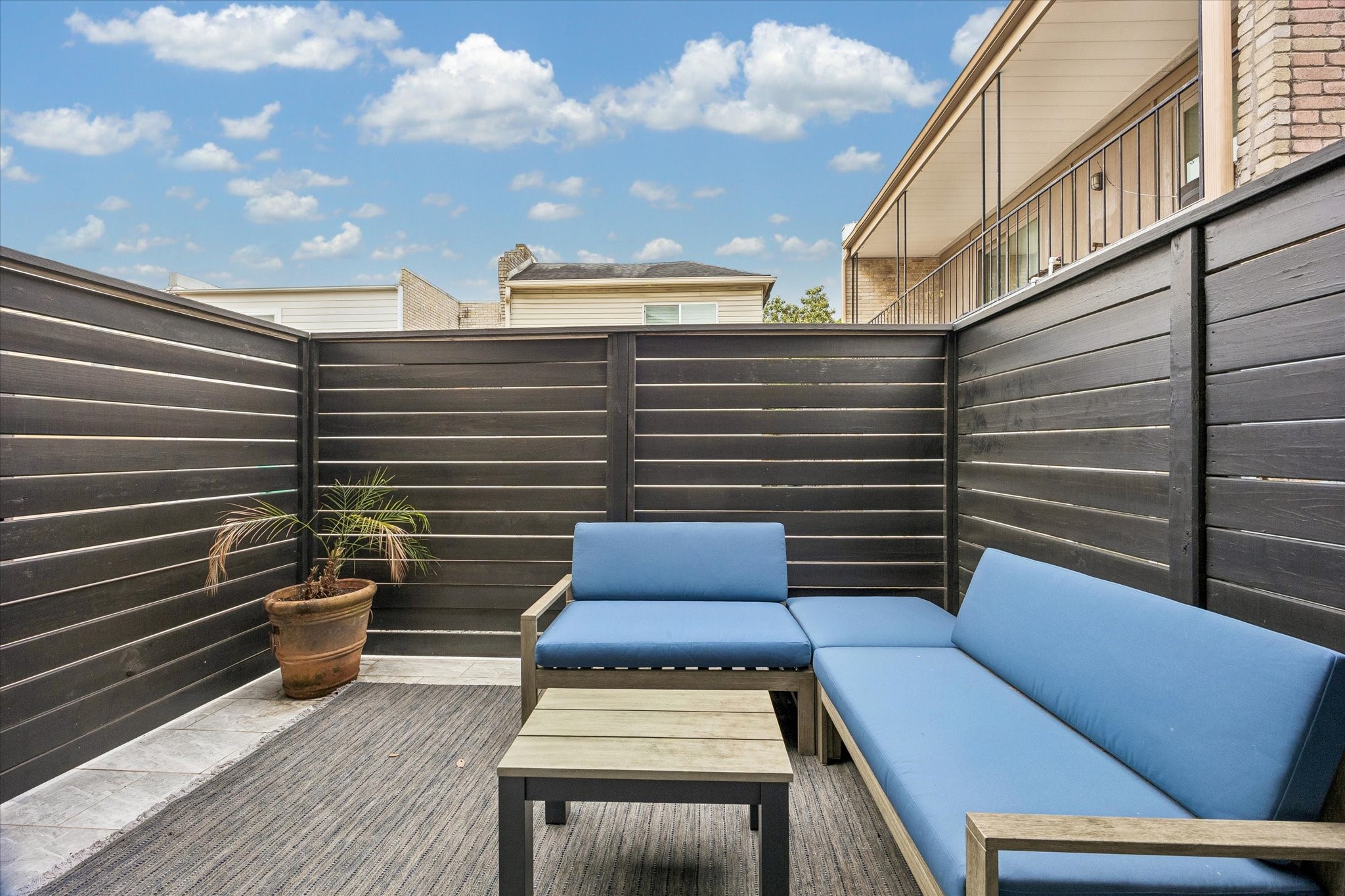1420 Indiana Street Houston, TX 77006 - Photo 26 of 31 This photo features a cozy outdoor patio with modern wood fencing, perfect for relaxation.