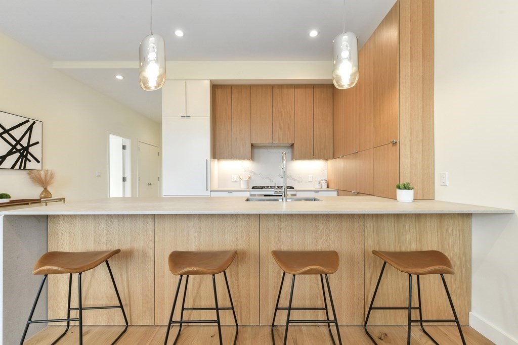 a kitchen with cabinets and chairs