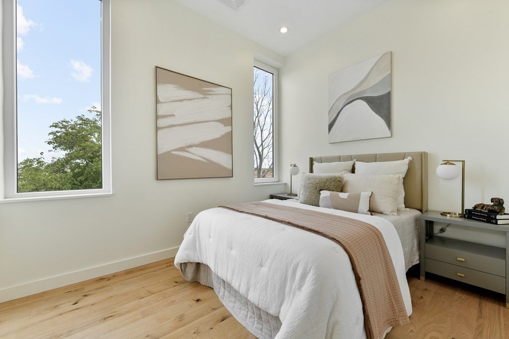 80 Terrace Street, Unit 302 Boston, MA 02120 - Photo 11 of 18 a bedroom with a bed and a painting on the wall