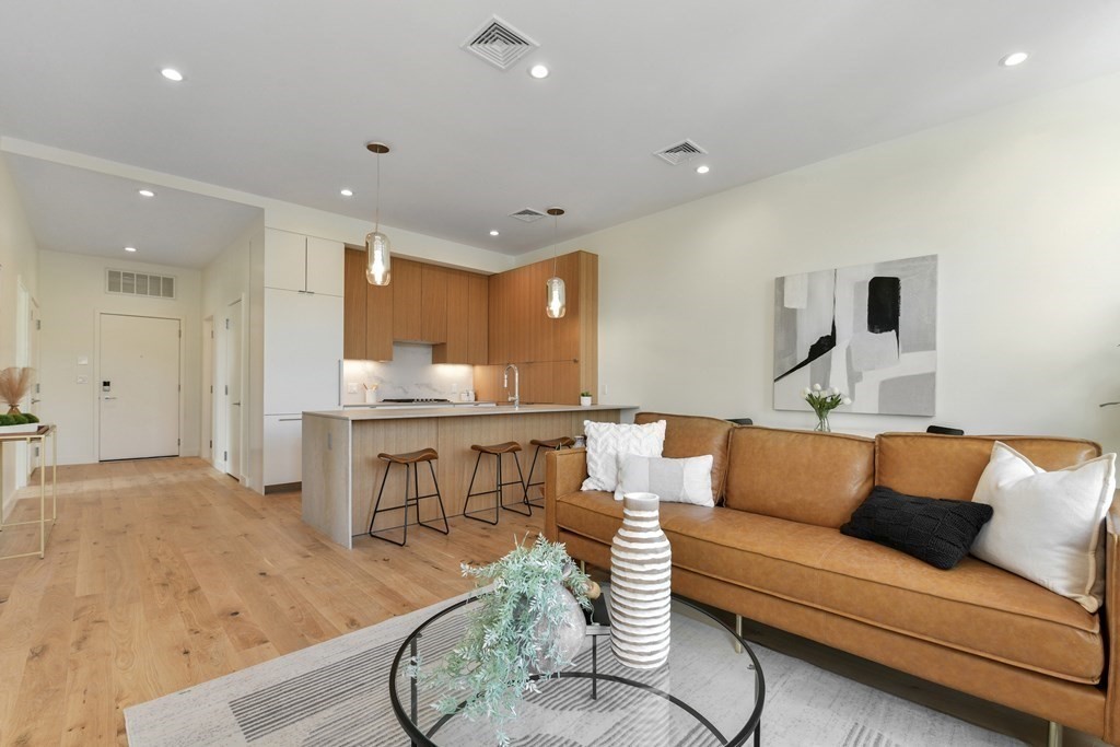 80 Terrace Street, Unit 302 Boston, MA 02120 - Photo 2 of 18 a living room with furniture and a table