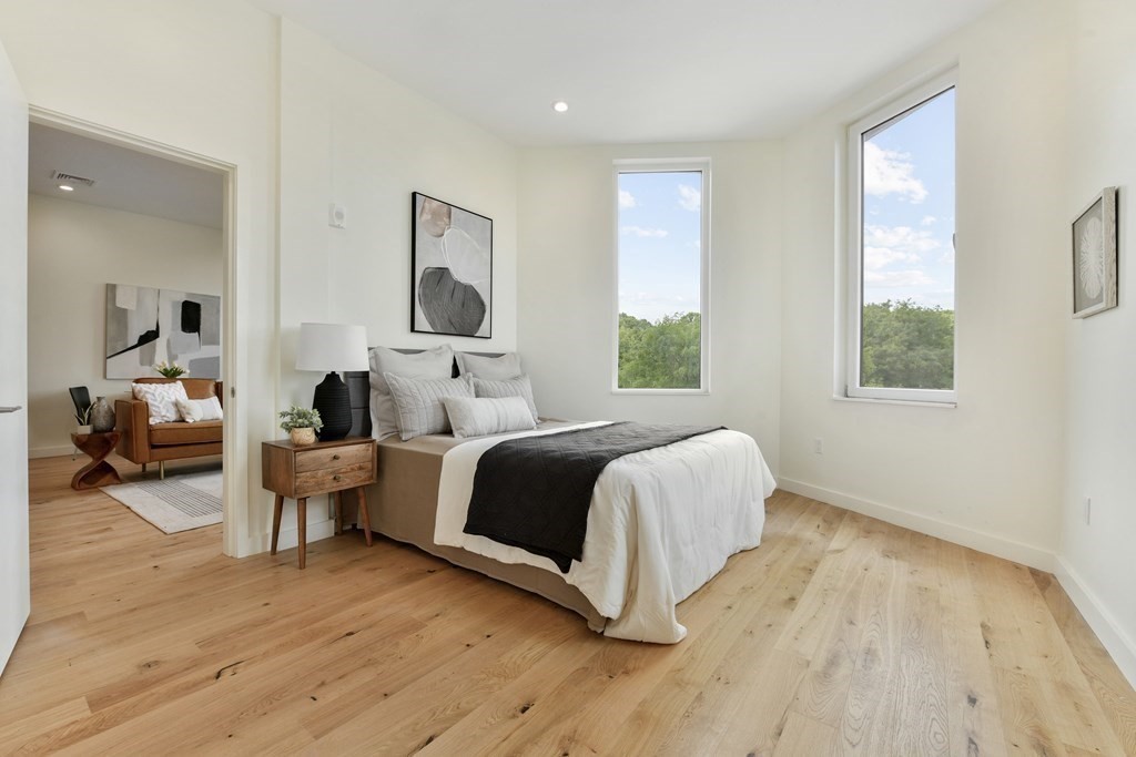 80 Terrace Street, Unit 302 Boston, MA 02120 - Photo 8 of 18 a spacious bedroom with a bed and wooden floor