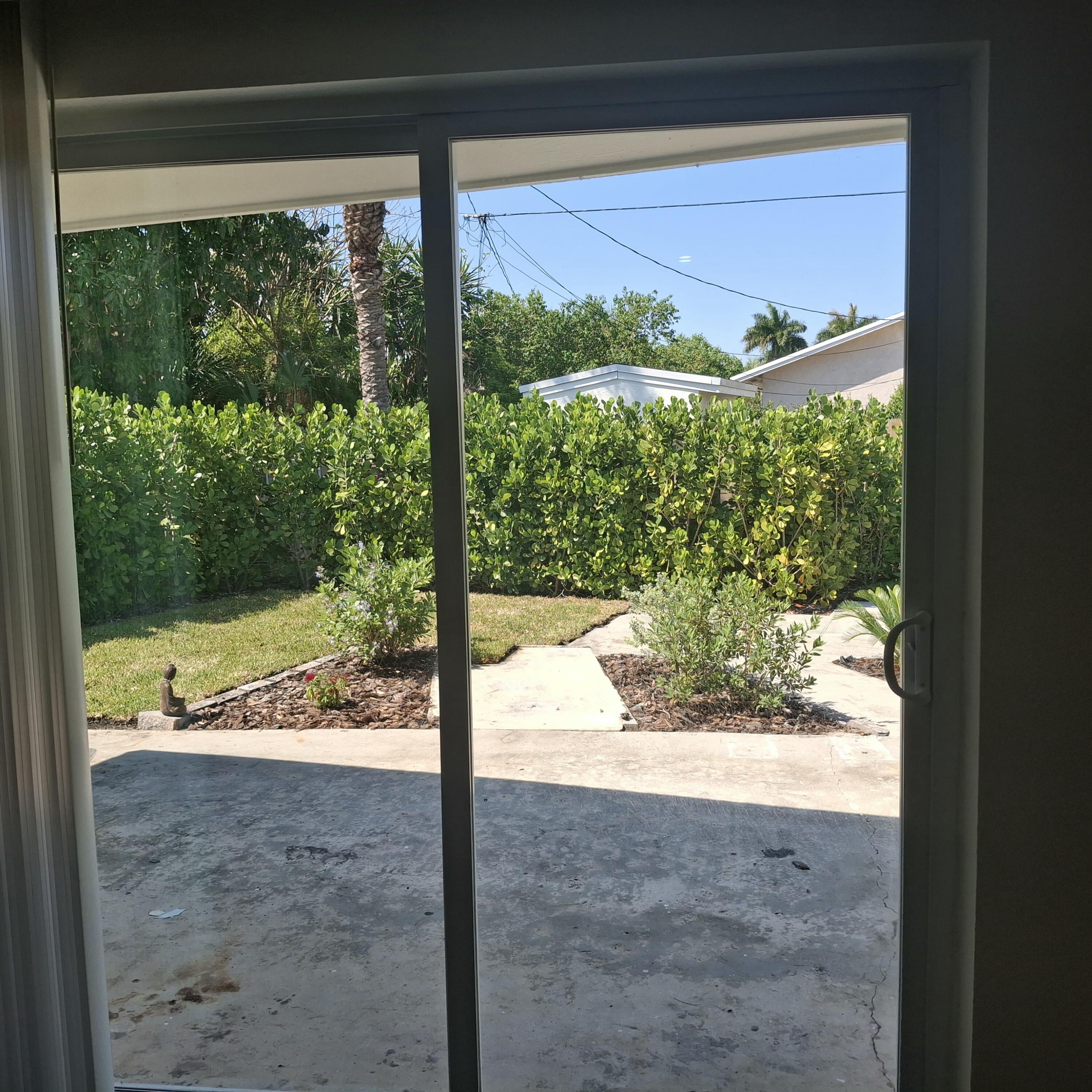 1097 Wilkinson Road, Unit B Lake Worth, FL 33462 - Photo 10 of 21 Sliding glass door to patio and yard