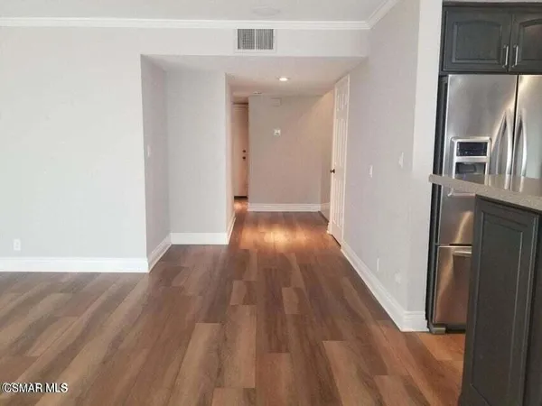 a view of a kitchen from a hallway