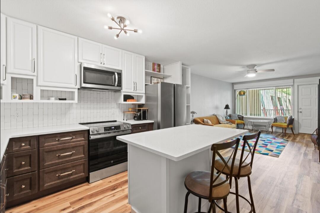 210 Pelham Road, Unit 211B Fort Walton Beach, FL 32547 - Photo 1 of 7 a kitchen with stainless steel appliances a stove top oven a sink dishwasher and a refrigerator