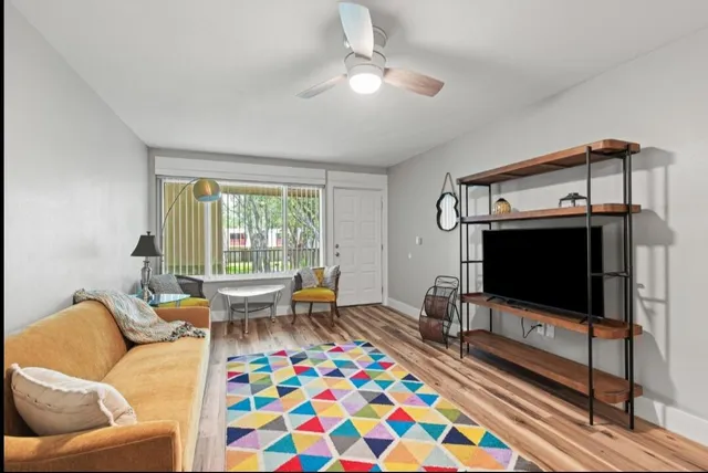 a living room with furniture and a flat screen tv