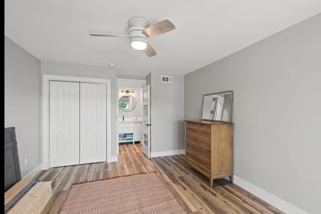 a living room with furniture and a dresser