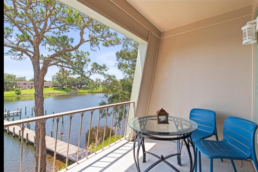 210 Pelham Road, Unit 211B Fort Walton Beach, FL 32547 - Photo 5 of 7 a view of a chairs and table in patio