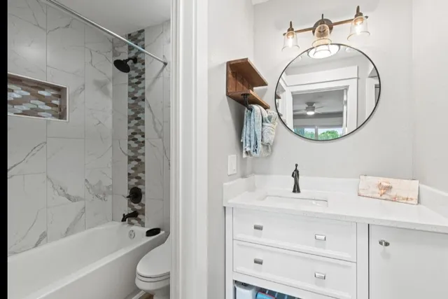 a bathroom with a sink a toilet and a mirror