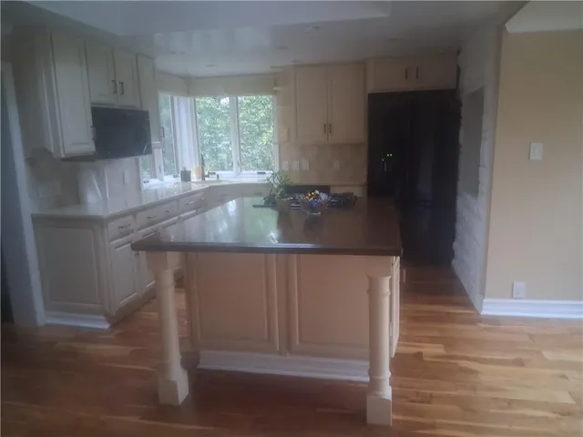 a kitchen with kitchen island a counter top space and a sink