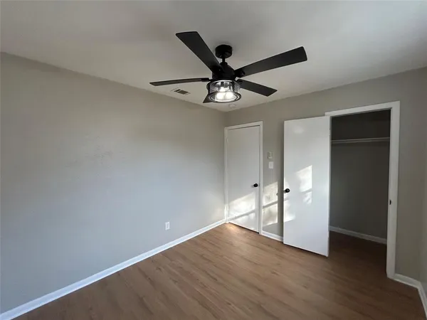 a view of an empty room and wooden floor