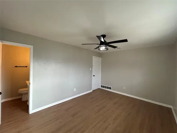 a view of a livingroom with a hardwood floor and a ceiling fan