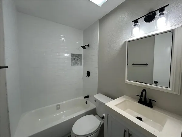 a bathroom with a sink toilet tub and shower