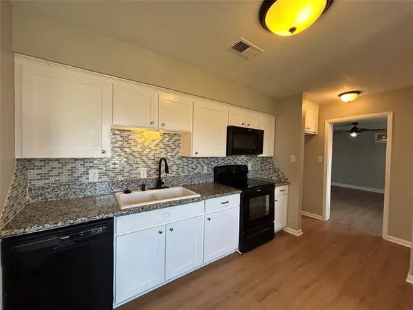 a kitchen with a sink and a stove top oven
