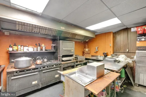 a kitchen with stainless steel appliances cabinets and wooden floor