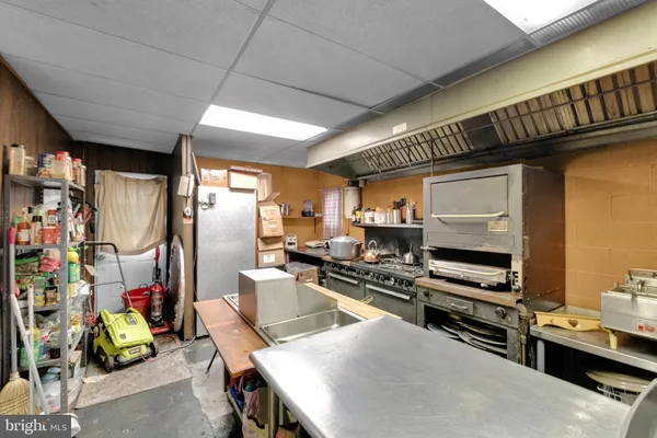 a kitchen with a refrigerator a sink and a stove