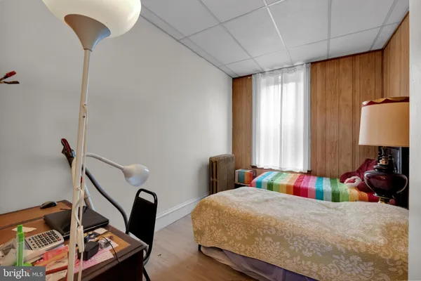 a bed room with a bed and a chair