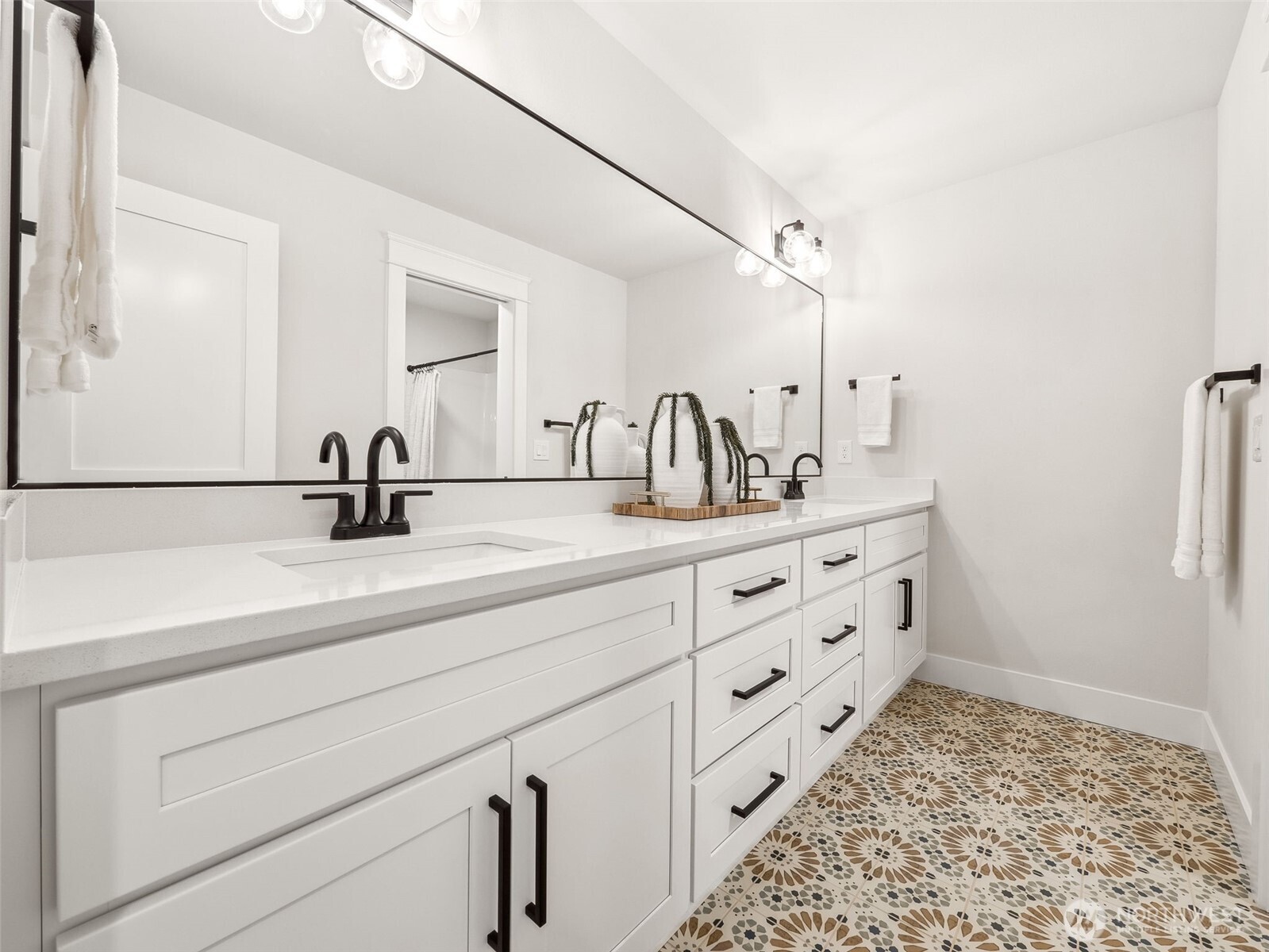 7226 227th Street East Graham, WA 98338 - Photo 16 of 31 a bathroom with a double vanity sink and mirror