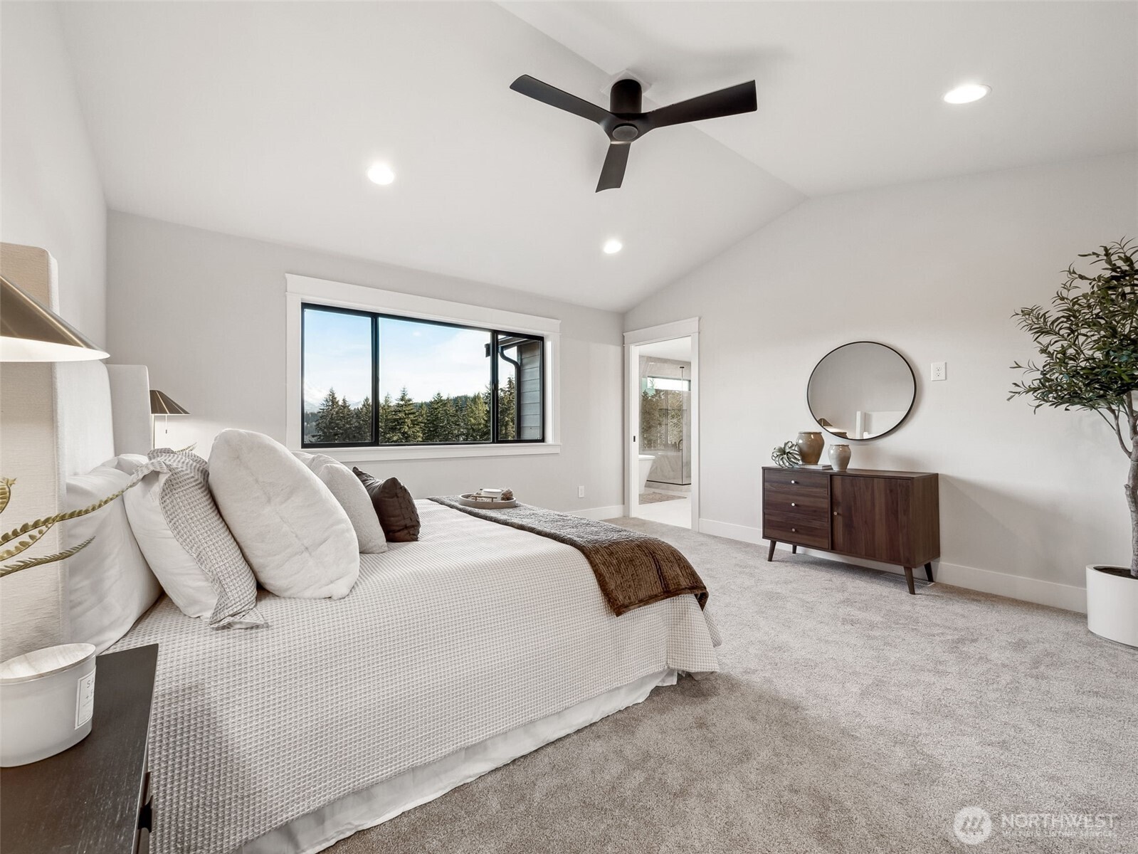 7226 227th Street East Graham, WA 98338 - Photo 20 of 31 a bedroom with a large bed and a chandelier
