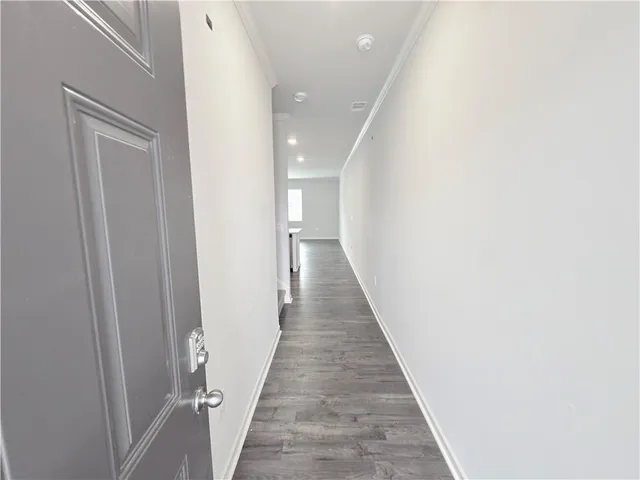 a view of a hallway with wooden floor