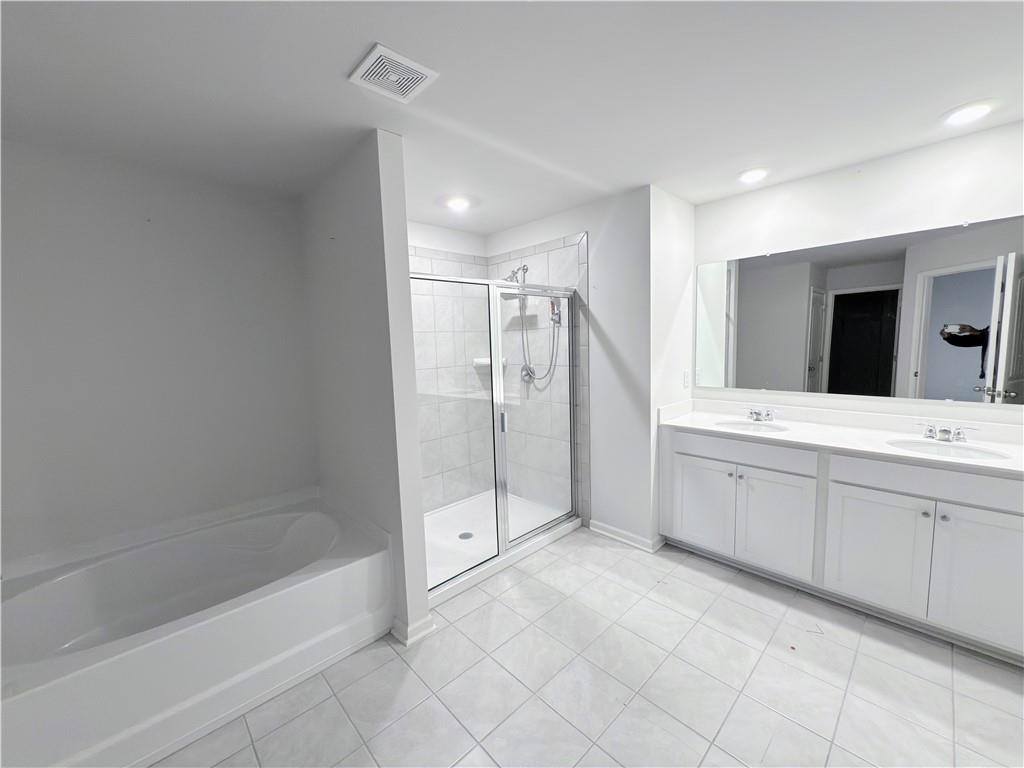 2715 Poppy Court Buford, GA 30519 - Photo 17 of 31 a bathroom with a bathtub sink and mirror