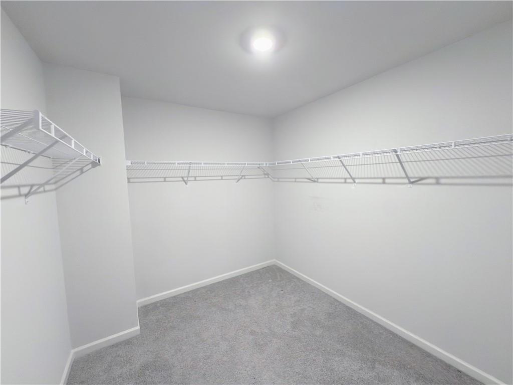 2715 Poppy Court Buford, GA 30519 - Photo 18 of 31 a view of a room with racks on the wall