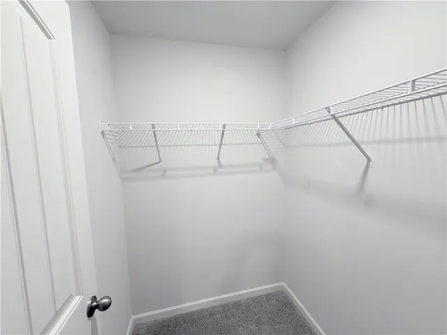 a view of an empty room and a bathroom