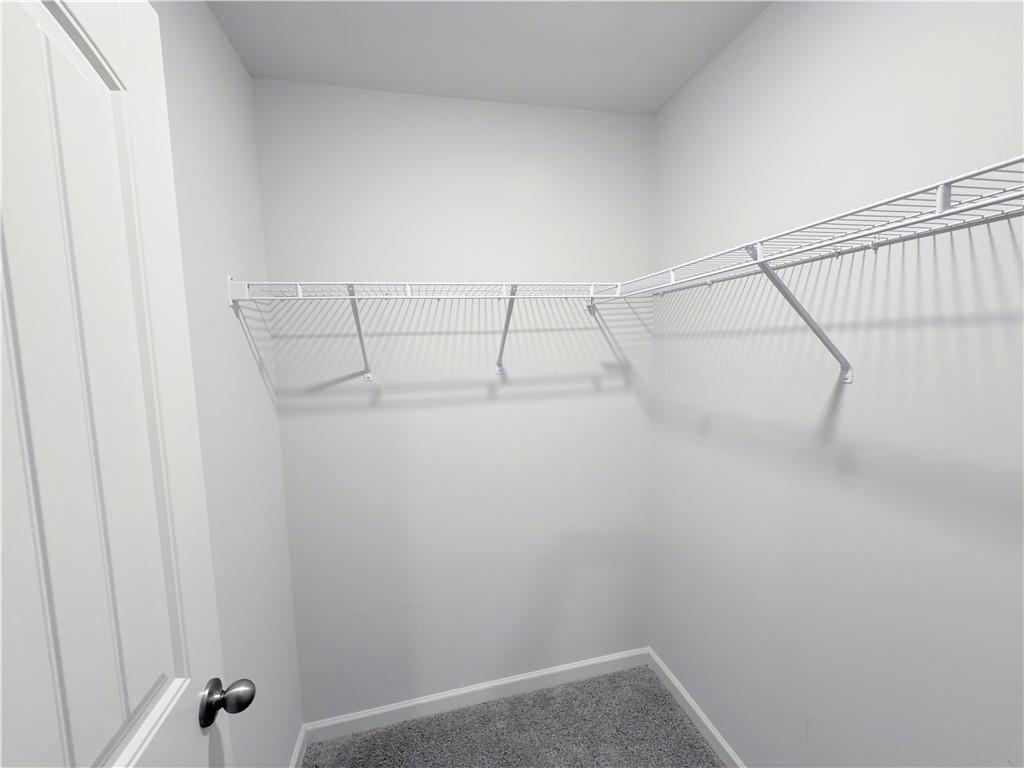 2715 Poppy Court Buford, GA 30519 - Photo 21 of 31 a view of a room with racks on the wall