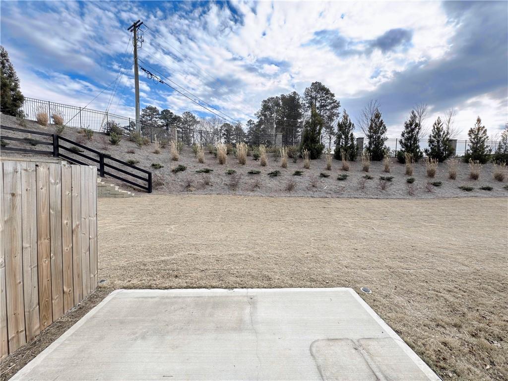 2715 Poppy Court Buford, GA 30519 - Photo 30 of 31 a view of a dry yard with wooden fence