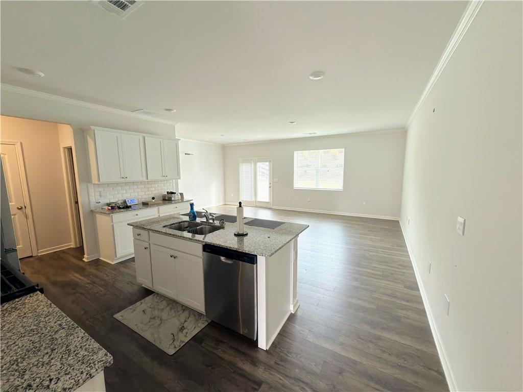2715 Poppy Court Buford, GA 30519 - Photo 6 of 31 a kitchen with stainless steel appliances granite countertop a stove a sink dishwasher and a refrigerator with wooden floor