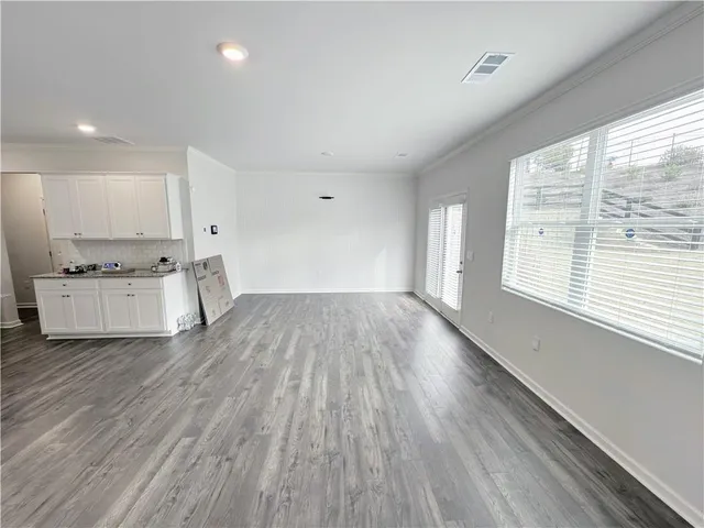 a view of a kitchen with wooden floor and a sink