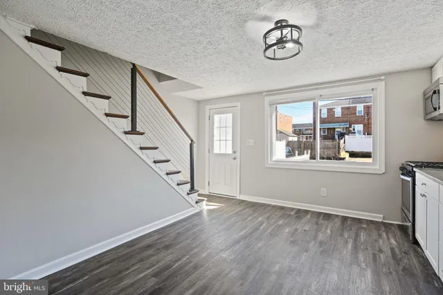 a view of room with window and wooden floor
