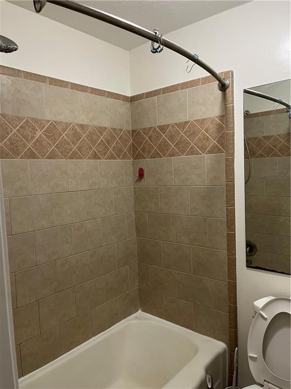 1432 Spring Valley Lane Lilburn, GA 30047 - Photo 8 of 11 a bathroom with a shower and a toilet
