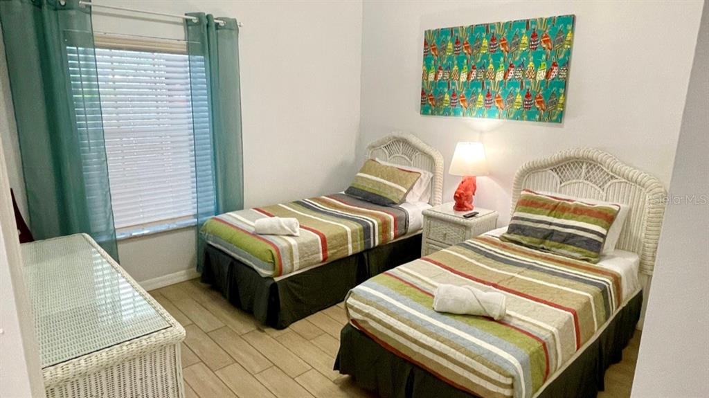 202 Rum Run, Unit 36102 Davenport, FL 33897 - Photo 11 of 21 a bedroom with two beds and painting on the wall