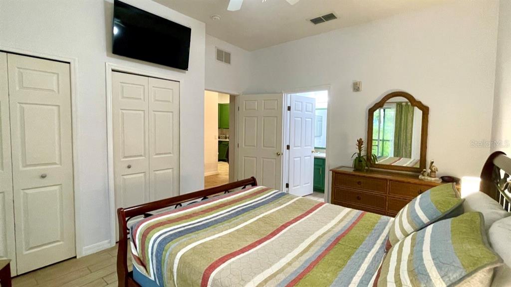 202 Rum Run, Unit 36102 Davenport, FL 33897 - Photo 12 of 21 a bedroom with a bed and a flat screen tv