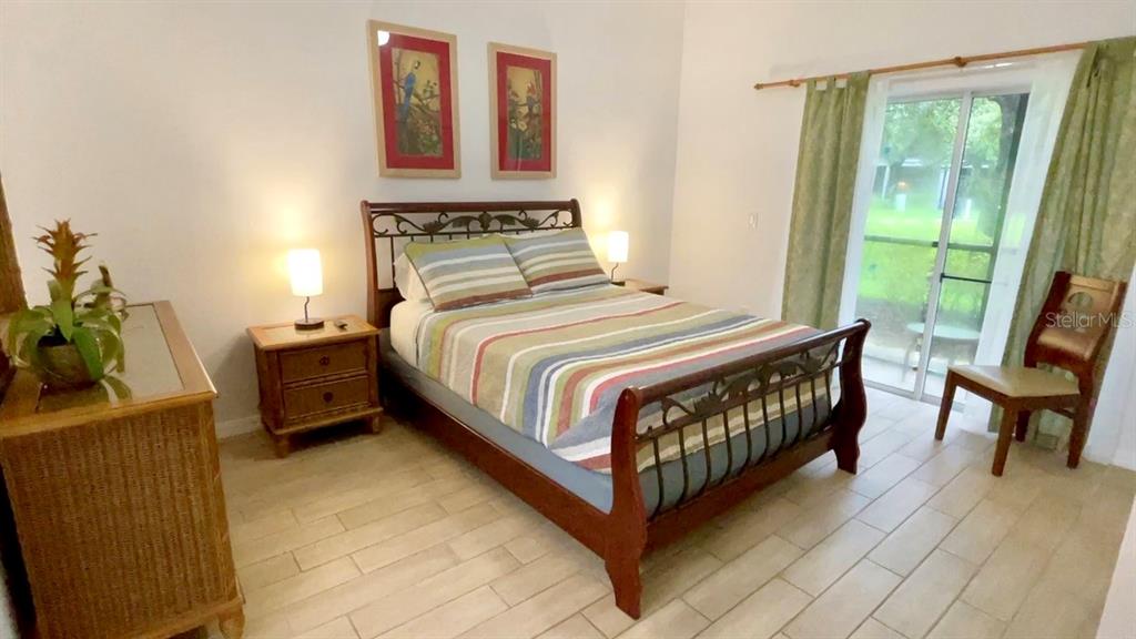 202 Rum Run, Unit 36102 Davenport, FL 33897 - Photo 13 of 21 a bedroom with a bed window and a table in it