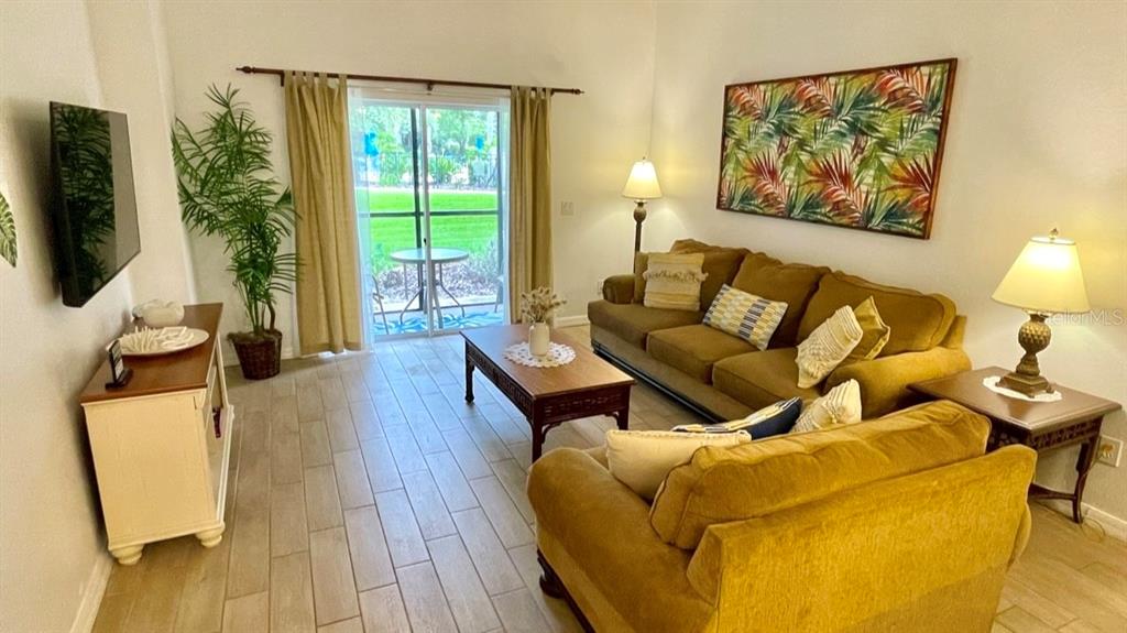 202 Rum Run, Unit 36102 Davenport, FL 33897 - Photo 3 of 21 a living room with furniture and a flat screen tv