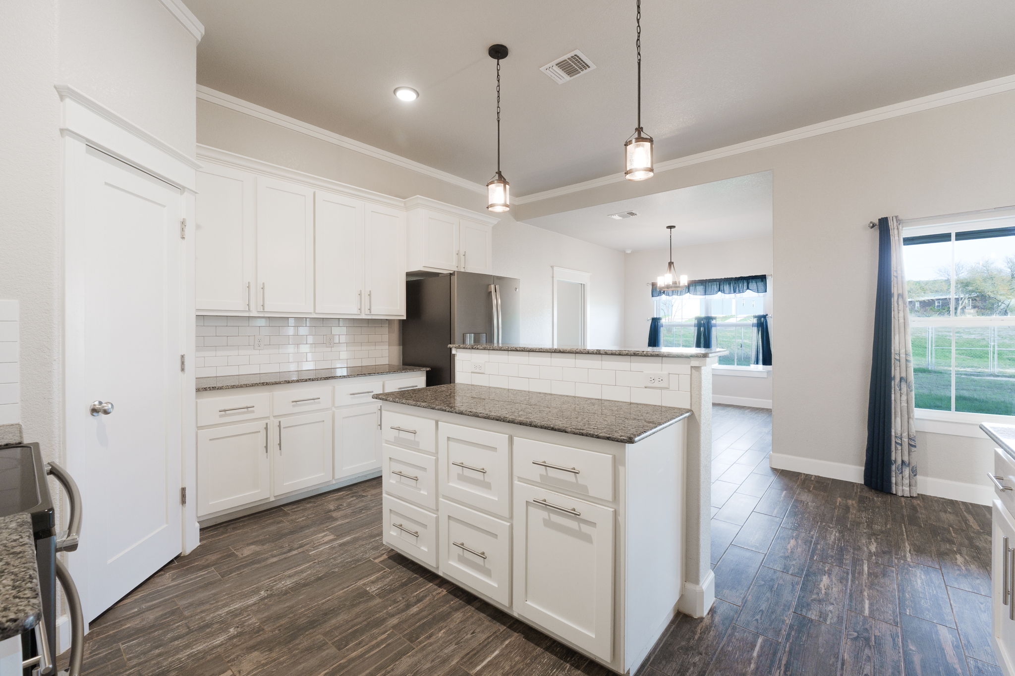 2662 Snow Road Kempner, TX 76539 - Photo 9 of 28 a kitchen with stainless steel appliances granite countertop a sink a stove a refrigerator and island with wooden floor