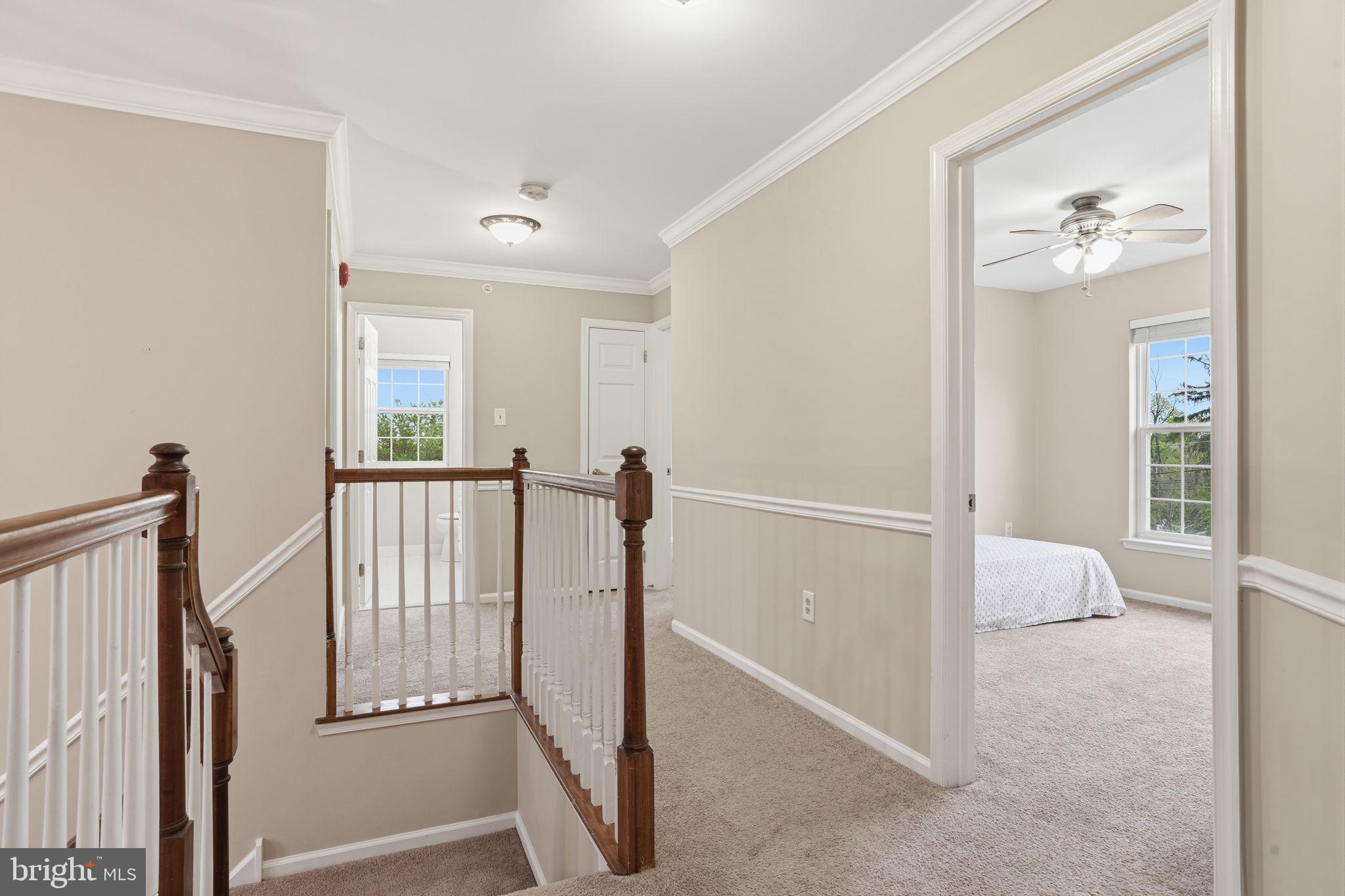 139 Statesman Road Chalfont, PA 18914 - Photo 34 of 64 a view of a hallway to a livingroom with wooden floor and stairs